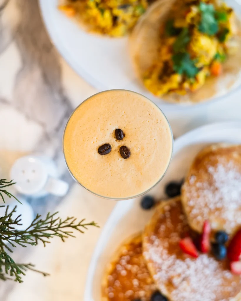 creamy espresso martini topped with three coffee beans on froth