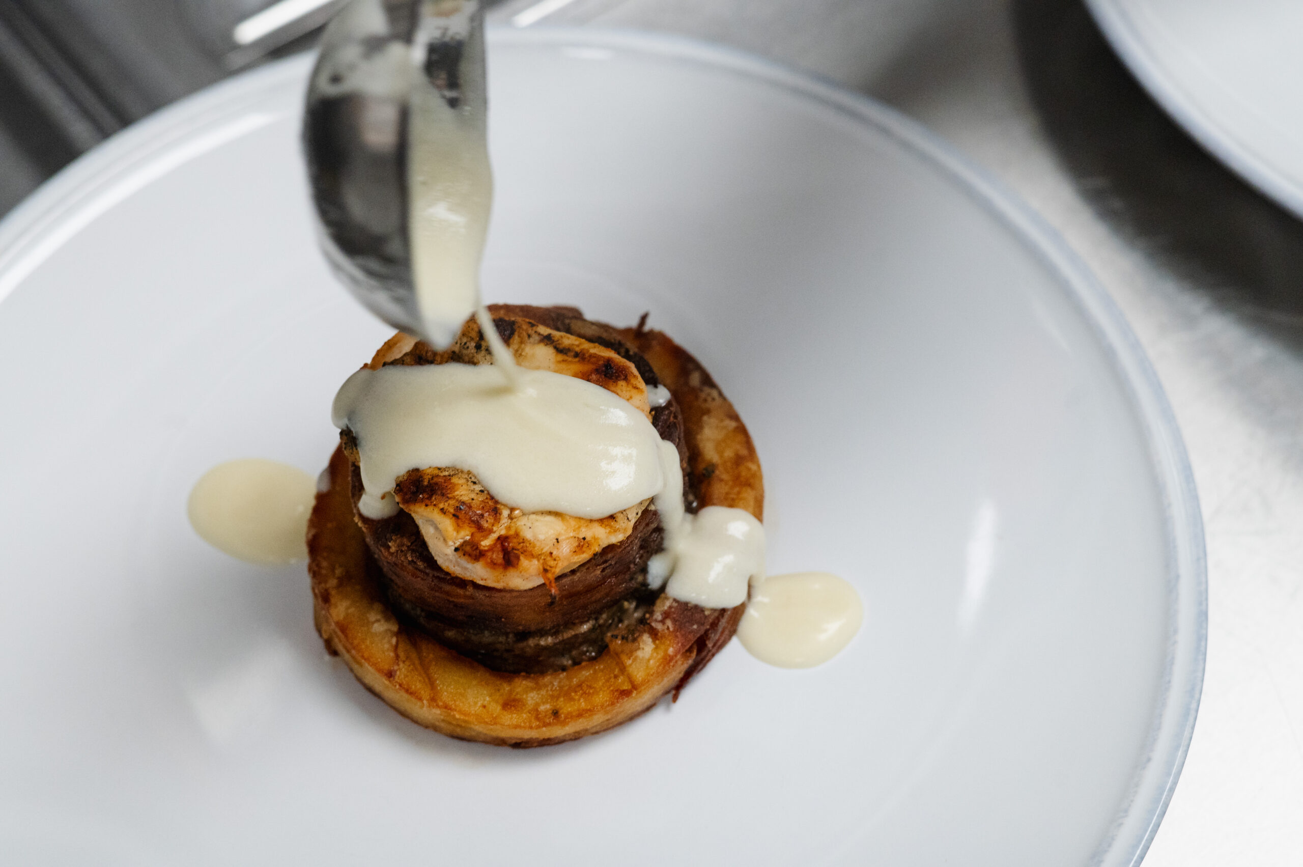 Top view of grilled dish with creamy sauce drizzled over.